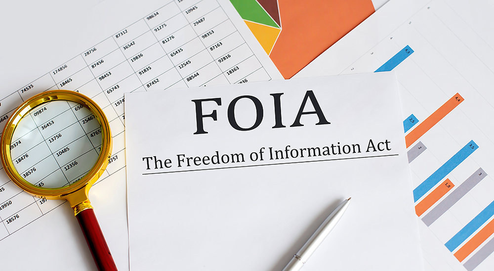 Paper with The Freedom of Information Act FOIA on a table SSUCv3H4sIAAAAAAAACnSRz07DMAzG70i8Q5XzKpY10I0jB248wcTBdcwaLUum/AGhae9O0rQjB7jFP9uf/cWX+7umYQN4hey5ueQoxUrr6IODoKxJeL2auSMjydWEpArWKdA1HCDgaOBECZqodcbXKcl8gBA9+TxsRgiBDkmjwJtE2Whf4mZJTMnUkVKMrSrm4zCxBRXxfzpfoleGvH94VQYM0l9Kb8ojaQ2GbPS/suXxvliFAxn8ntxULh1pguJyX0rZ8SuQO9W+IUplK8ufFkHngq5SOjuFyhyqNhvG6QRLG9pogssr3D6EaWvPMOj8/x9JkxY+gvepXC68GoTp4PZUzTE2TAZmVSbTmXLIu023E6Lre7HlohNPYi4opx1V0pnWWYRSjEcla+sqb8AIibbYb1qOXLZih7wdeNe3m+6Ry4H3fECRPv76AwAA//8DAJrJGBCkAgAA