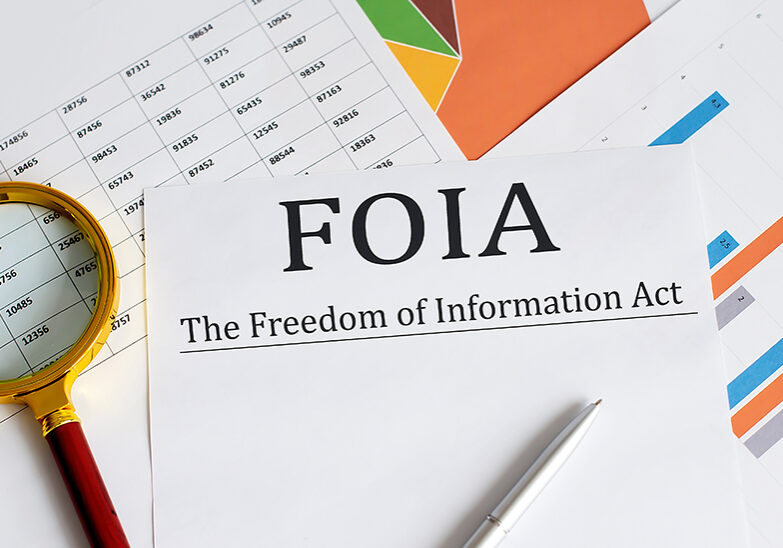Paper with The Freedom of Information Act FOIA on a table SSUCv3H4sIAAAAAAAACnSRz07DMAzG70i8Q5XzKpY10I0jB248wcTBdcwaLUum/AGhae9O0rQjB7jFP9uf/cWX+7umYQN4hey5ueQoxUrr6IODoKxJeL2auSMjydWEpArWKdA1HCDgaOBECZqodcbXKcl8gBA9+TxsRgiBDkmjwJtE2Whf4mZJTMnUkVKMrSrm4zCxBRXxfzpfoleGvH94VQYM0l9Kb8ojaQ2GbPS/suXxvliFAxn8ntxULh1pguJyX0rZ8SuQO9W+IUplK8ufFkHngq5SOjuFyhyqNhvG6QRLG9pogssr3D6EaWvPMOj8/x9JkxY+gvepXC68GoTp4PZUzTE2TAZmVSbTmXLIu023E6Lre7HlohNPYi4opx1V0pnWWYRSjEcla+sqb8AIibbYb1qOXLZih7wdeNe3m+6Ry4H3fECRPv76AwAA//8DAJrJGBCkAgAA